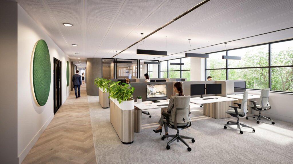 Modern open office space with workstations, large windows, and indoor plants at De Entree.